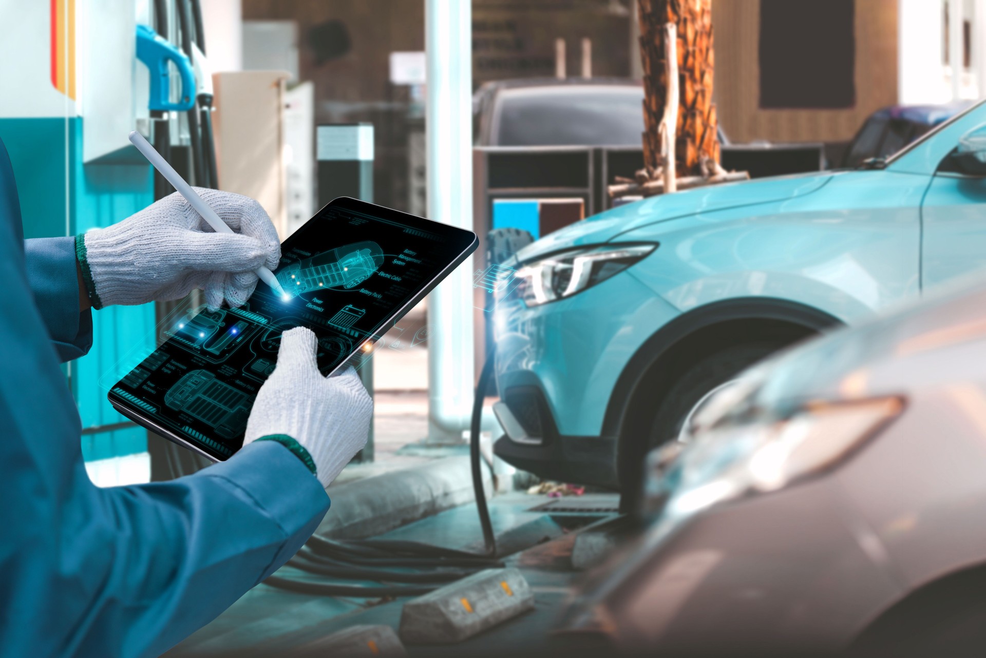 EV electric vehicle technology concept, mechanic employing EV electric vehicle analysis display screen at electric car manufacture